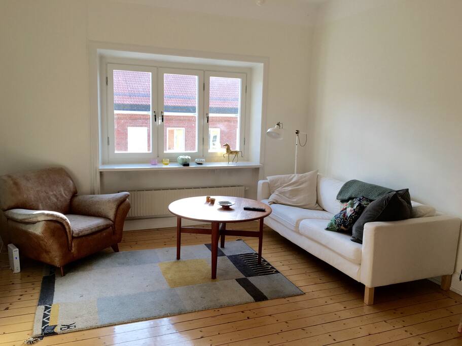 Large living room with TV, stove, overlooking the street