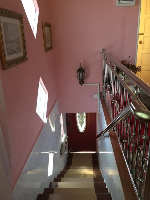 Flight of stairs to the first floor with safety railing