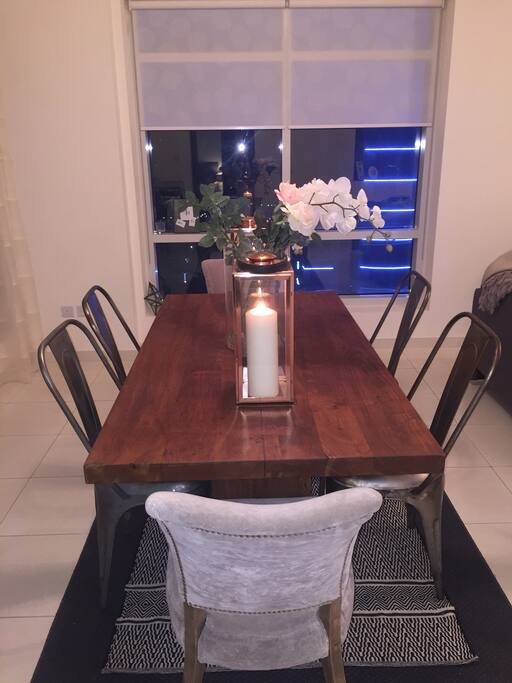 Large dining room table in front of Marina view window.