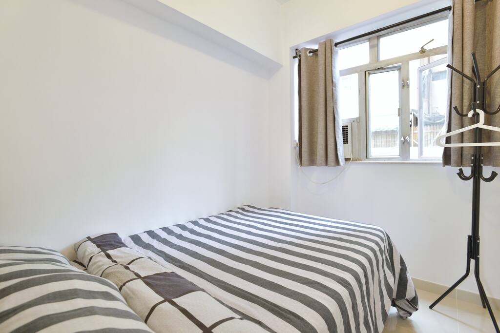 Bedroom with double bed and cloak hanger.