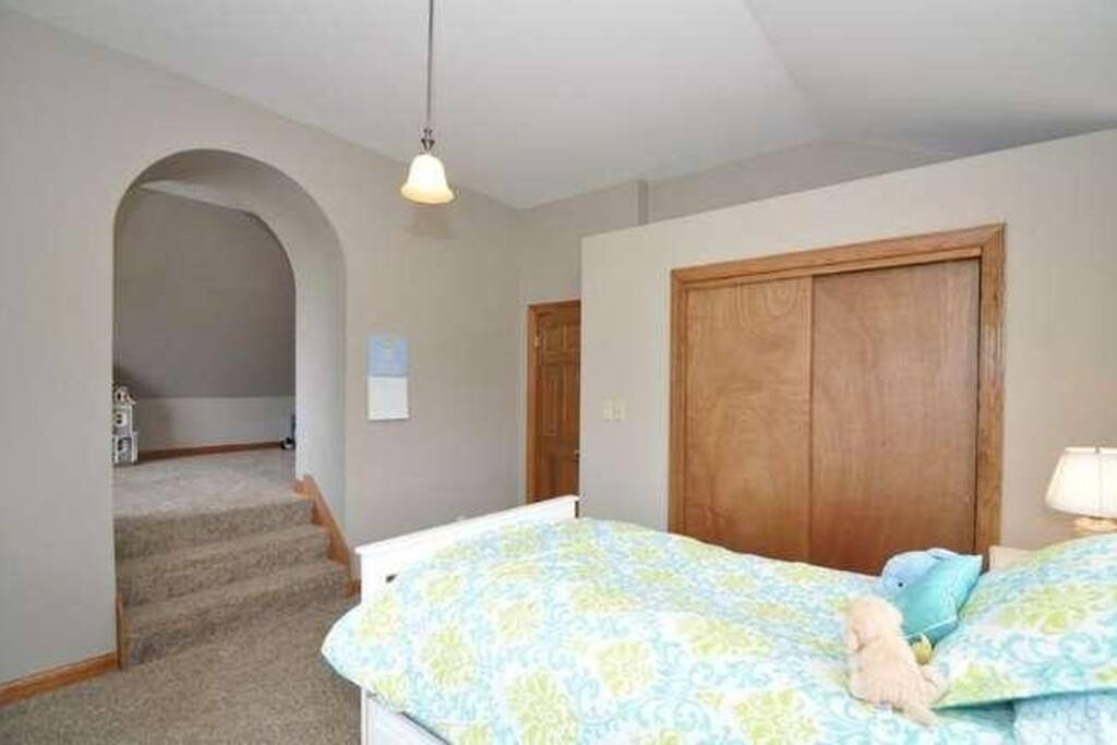 guest room with divided upper section (currently contains kids play gym)