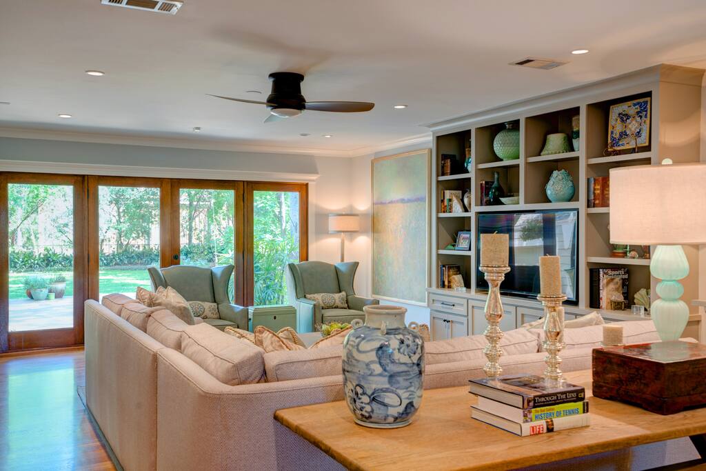 Lounge in the comfortable living room with backyard views and a Curve TV