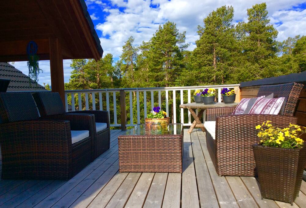 Large porch with lounge and dining table for cozy togetherness on hot days.