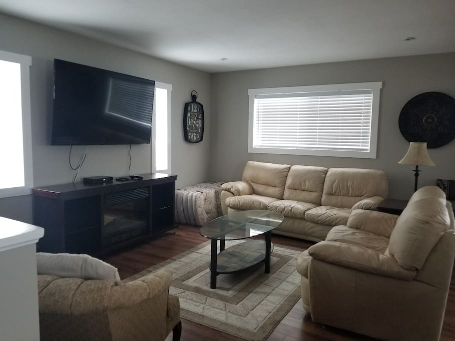 Living Room with leather sofas, 60" TV with Shaw Cable and internet included
