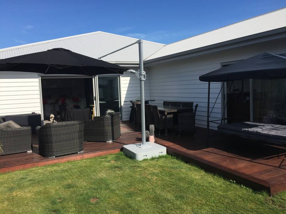 Private shared deck with lounge suite, table & chairs, and swing seat.