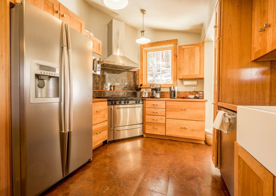 Recently remodeled kitchen with granite counter tops, stainless steel appliances, and a professional-grade six burner gas range