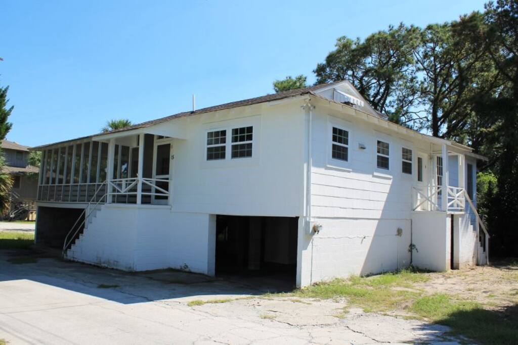 This classic Tybee cottage features a large wrap-around screened porch to enjoy the ocean breezes and sounds of the surf