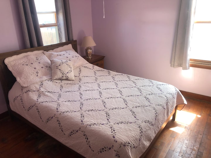 Master bedroom on main level includes a Queen bed with Purple brand mattress
