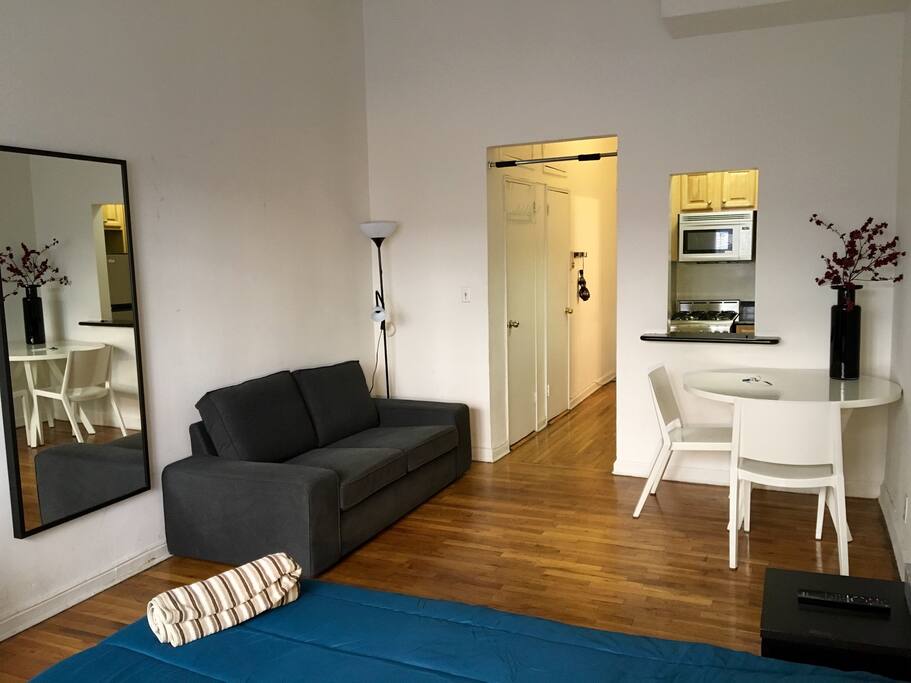 Comfy couch to lounge on and a full size dressing mirror