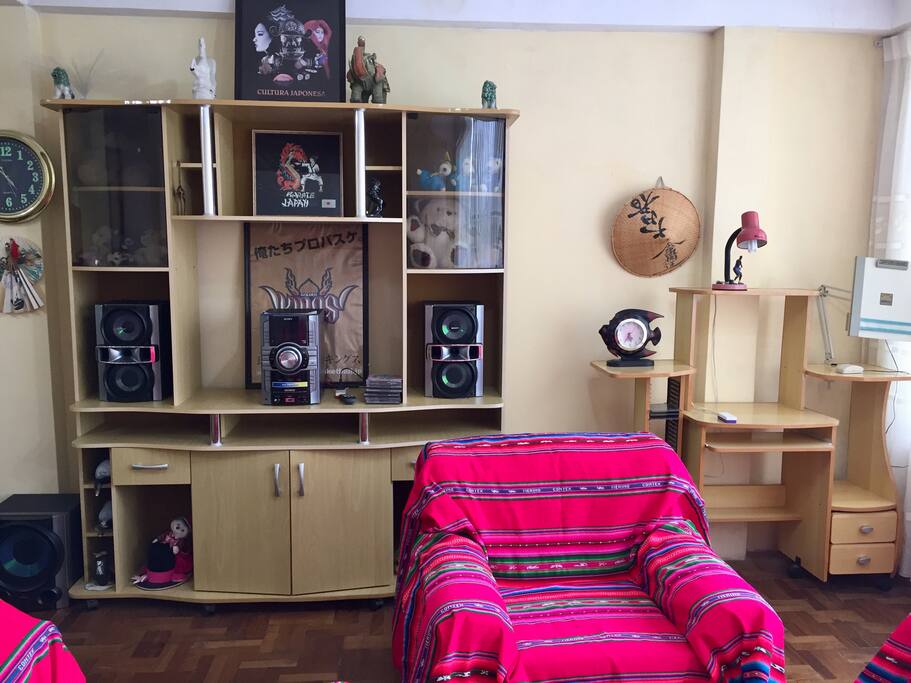 Living room equipped with a stereo and a laptop friendly workspace