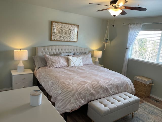 The master suite features a spacious king bed with down duvet, beautiful mountain views, ample closet space, and an attached private bathroom.