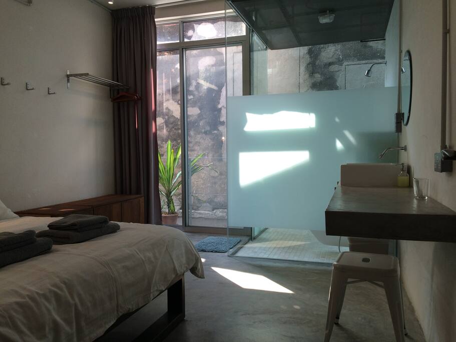 The glass partition that separates the bathroom, allows more natural light into the room.