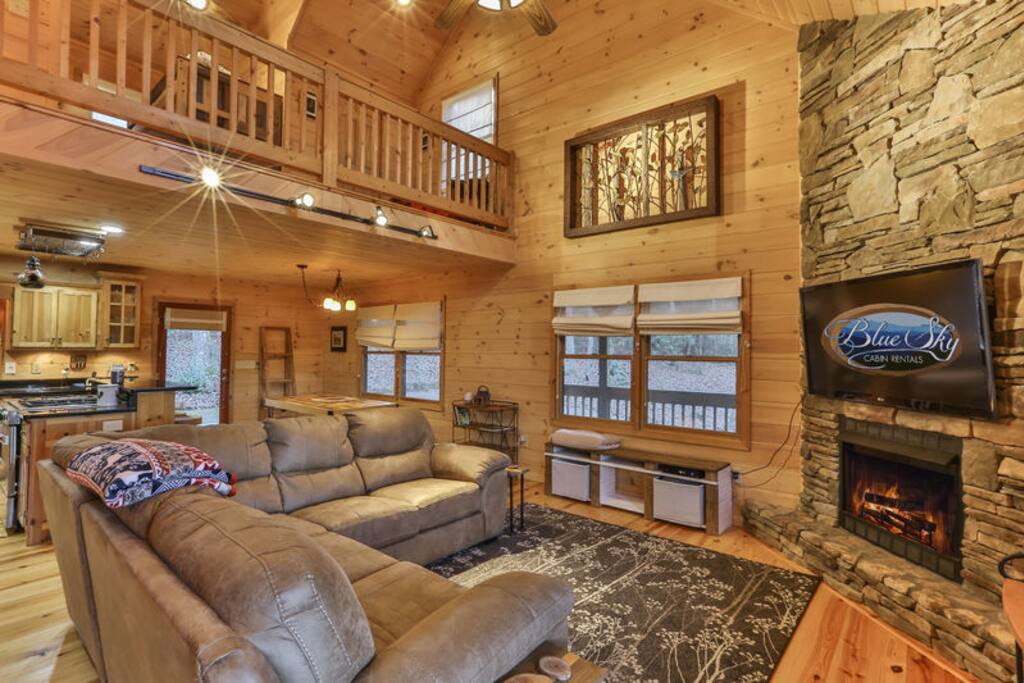 Open living area with fireplace and 60" TV.