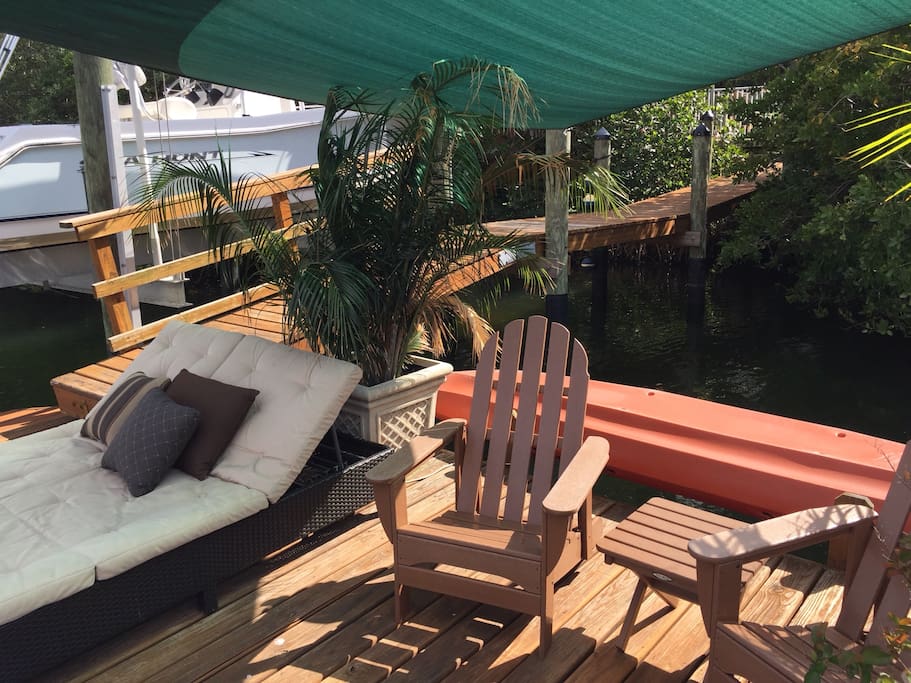 Floating dock with several chairs, double chaise lounger.