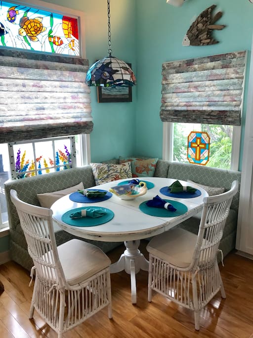 Dining area with L-shape sofa & 2 chairs. Sits 5 or 6.