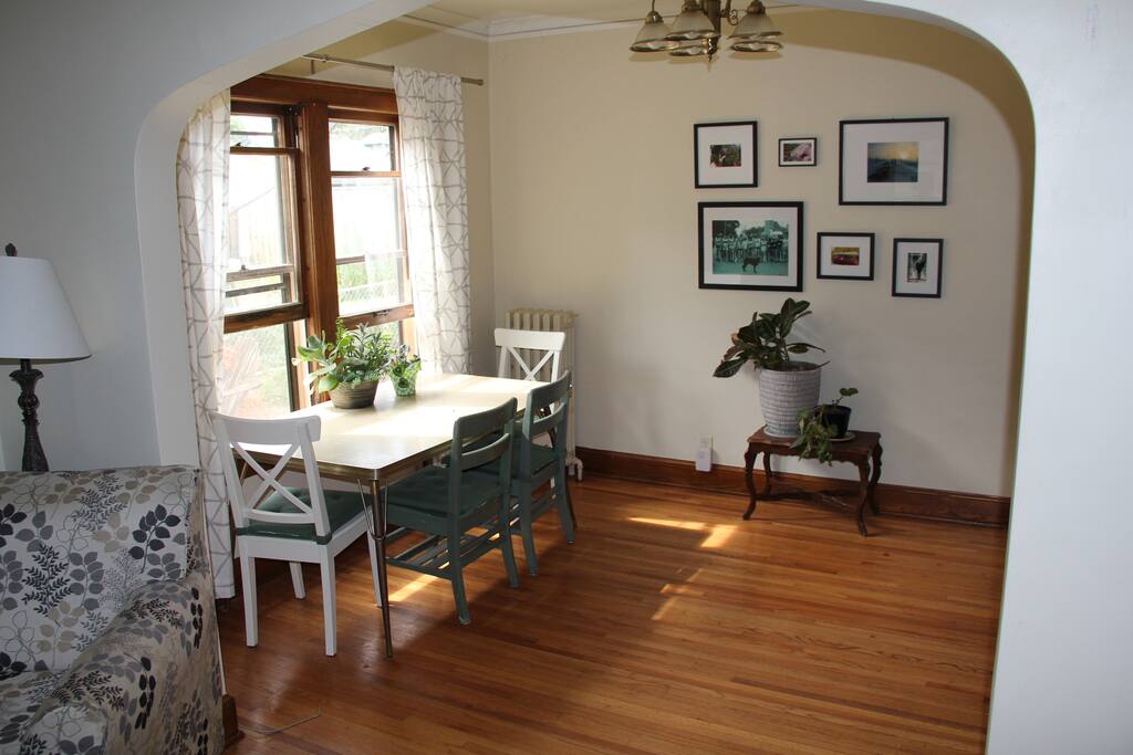 A large, arched doorway connects the living room to the dining room.