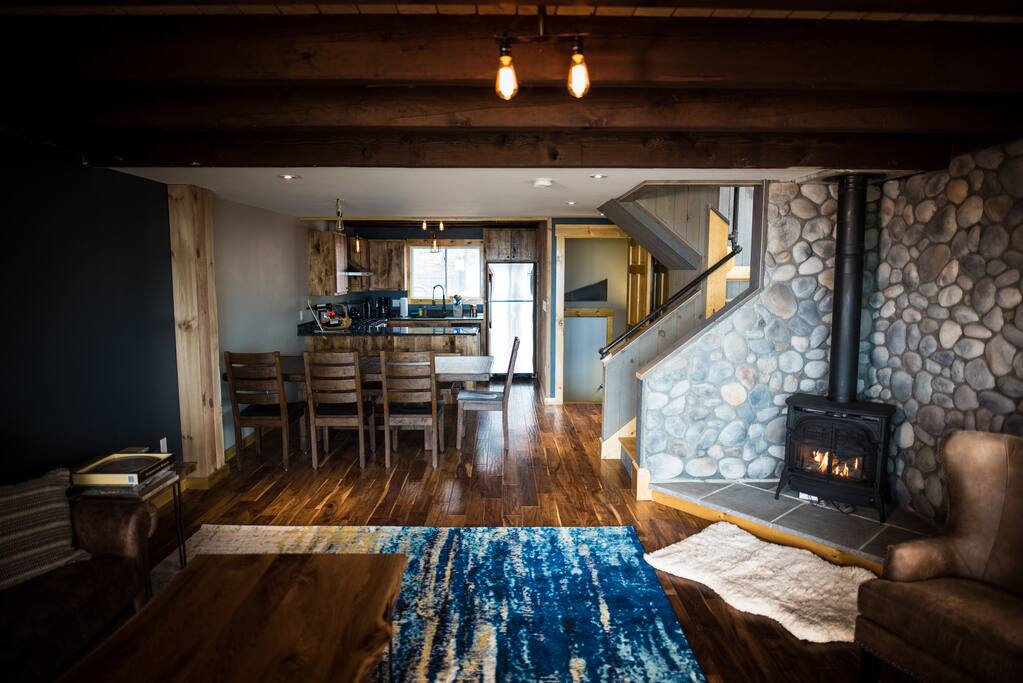 looking from living room to dining room to kitchen - cozy Vermont Casting propane fireplace
