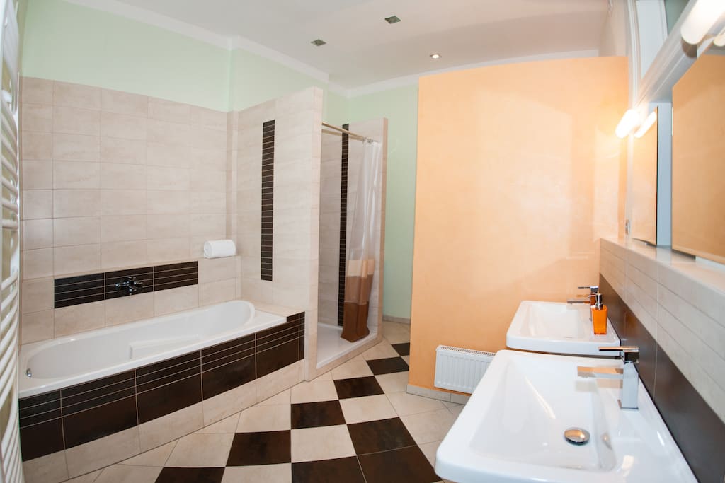 Bathroom with bathtub, shower, bidet and WC and equipped by warm floors