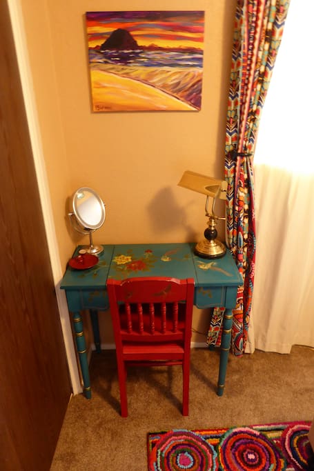 A beautiful hand-painted desk with make up mirror to get ready in the morning.