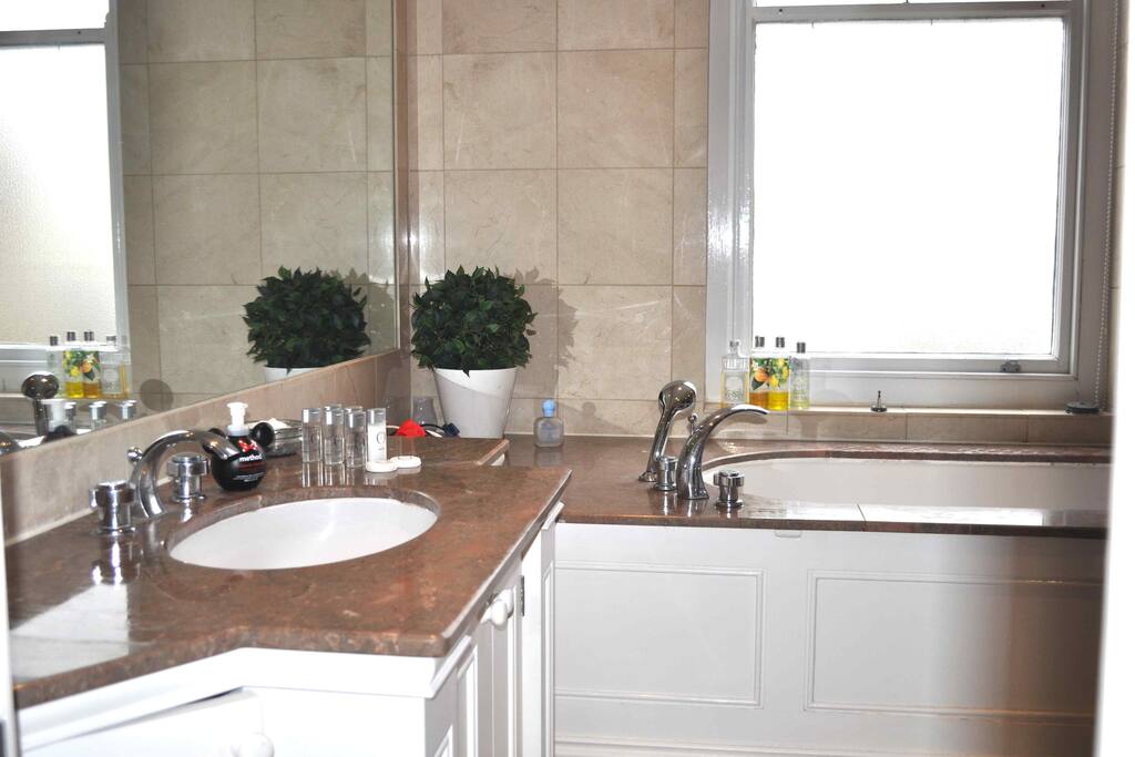 Private bathroom, bath, sink, and toilets