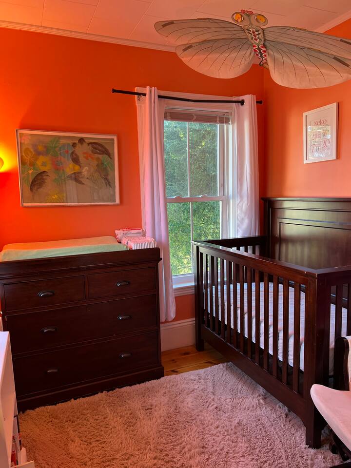 Nursery off the bedroom with a changing table and crib.