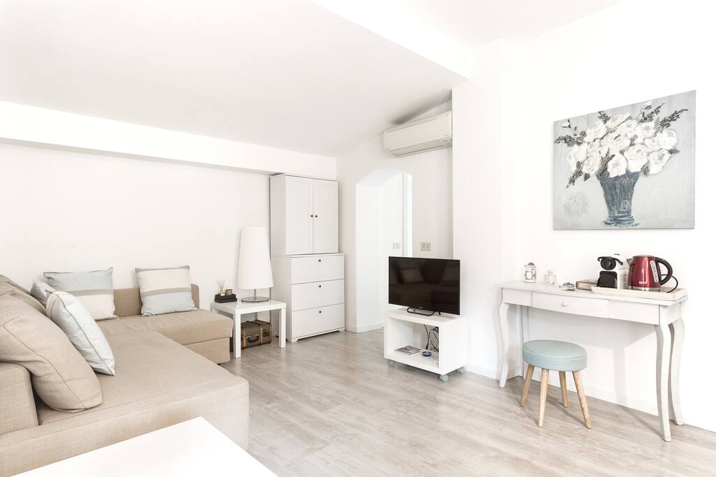 The living room (TV, AC, sofa bed) - on the right the kitchen