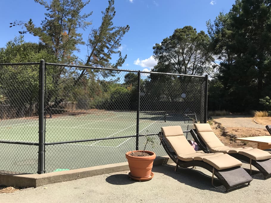 Tennis Court and Lounge Chairs in very large yard