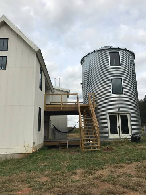 Side view of the house, looking north. You can enter the silo bedroom directly from the driveway via these wooden stairs.