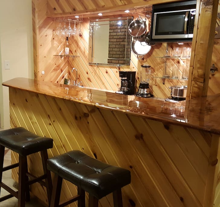 Refrigerator, microwave, dishwasher, hot plate, coffee maker, dishes and cutlery.