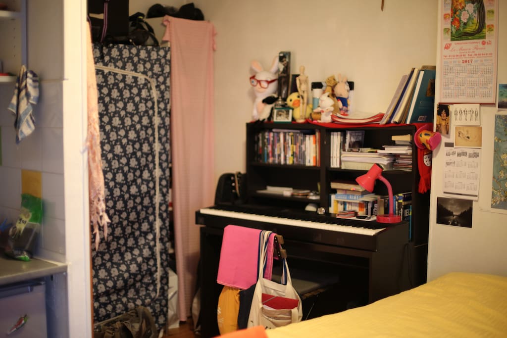 a desk with a chair and a piano on it and a cute little lamp