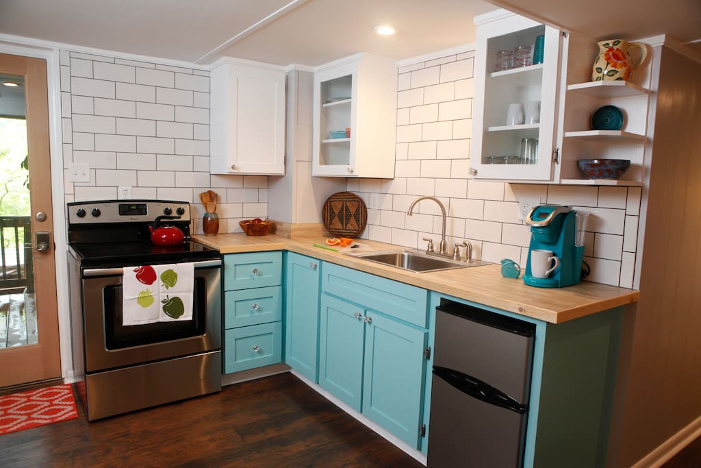 Kitchen is well stocked with dishware, cookware, coffee, tea, and spices