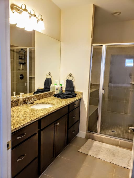 The bathroom is equipped with high end finishes. There is plenty of room in the closet to hang your clothes.
