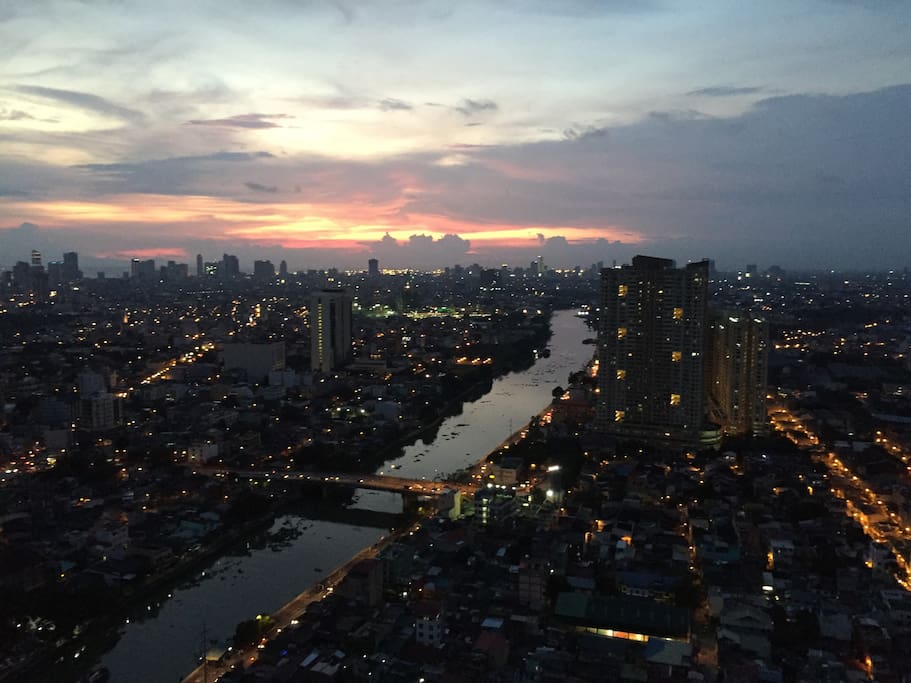 Stunning view of Pasig River and Manila from the room at dusk