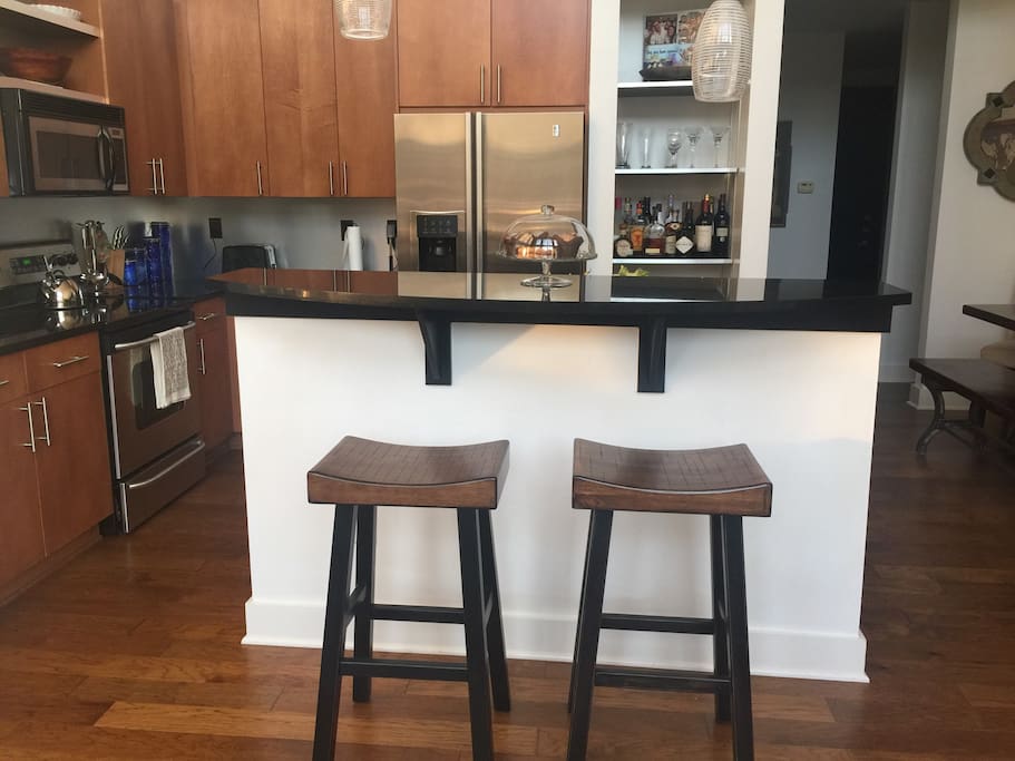 Open floor plan highlighting the beautiful modern kitchen and bar...
