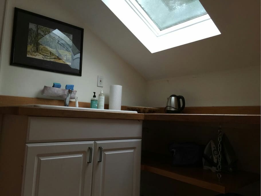 Kitchen comes stocked with an electric kettle, dorm fridge, plates, cups and utensils.