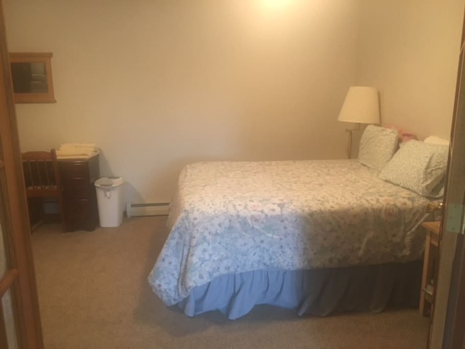 Queen bed and desk in lower bedroom with French doors. Partial bath on this level.