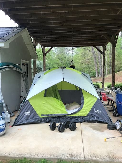 Tent under roof with queen air mattress.