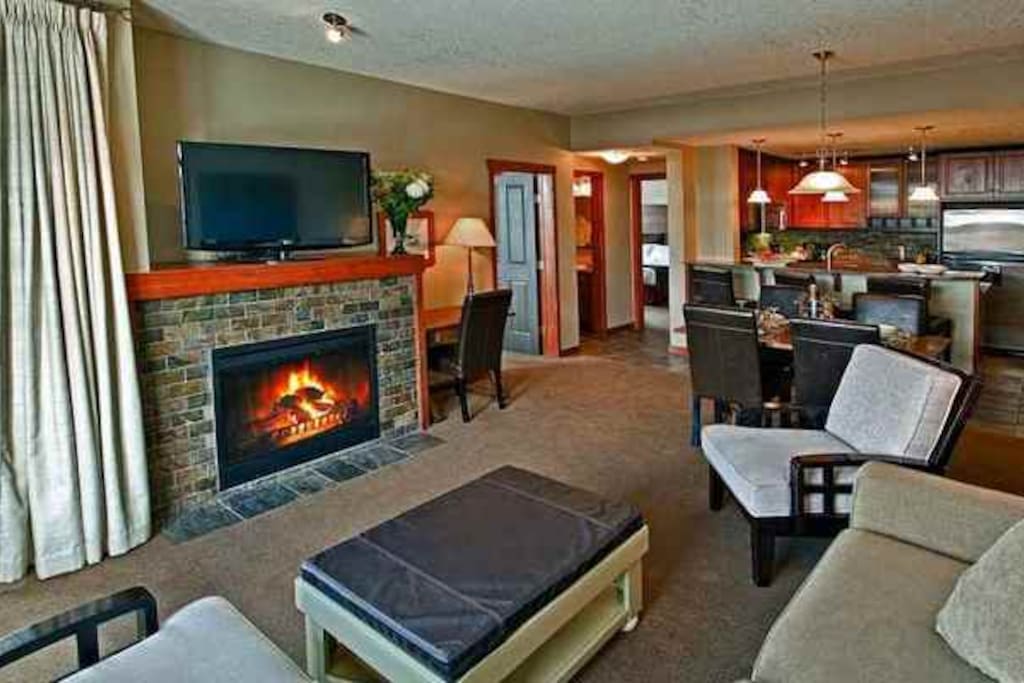 This comfortable condo features a cozy fireplace and modern kitchen