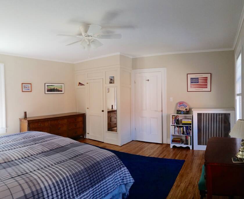 Large room with dresser and closet available for use.