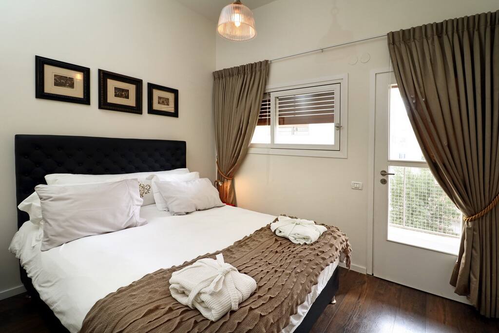 One of the two bedrooms in the suite, a queen size bed with luxurious sheets and linen. This bedroom also has a dedicated exit to the balcony.