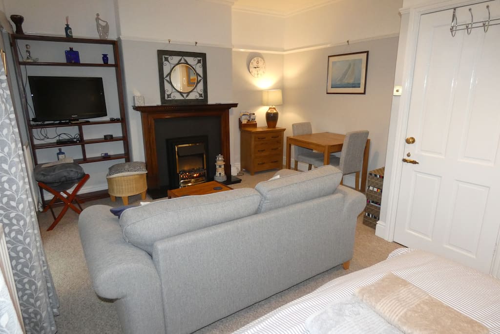 Lounge area, with electric fire, Wide screen TV with chromecast and DVD player. We have a large selection of DVDs for you to choose from. The door on the right leads through the vestibule and bathroom.