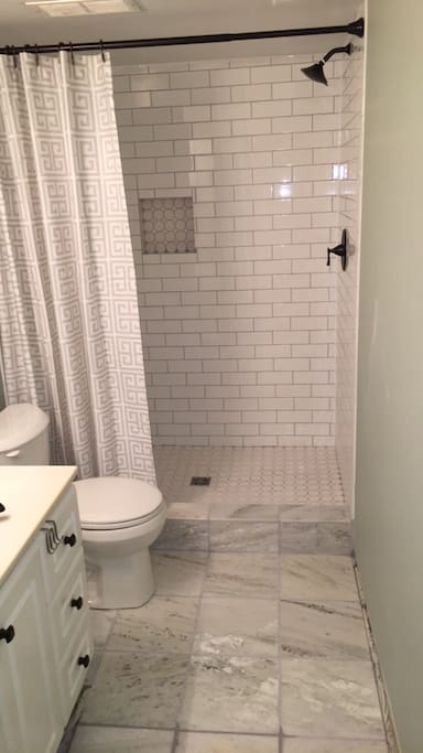 Private bathroom with brand new marble floors and subway tile walk in shower!