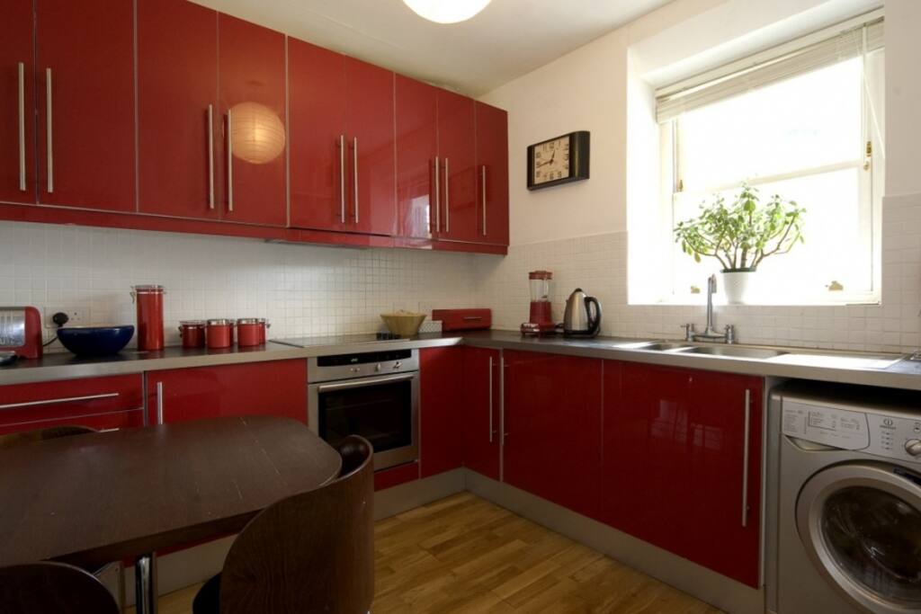 The kitchen includes a washer/dryer and is equipped with a wide range of condiments (herbs and spices).