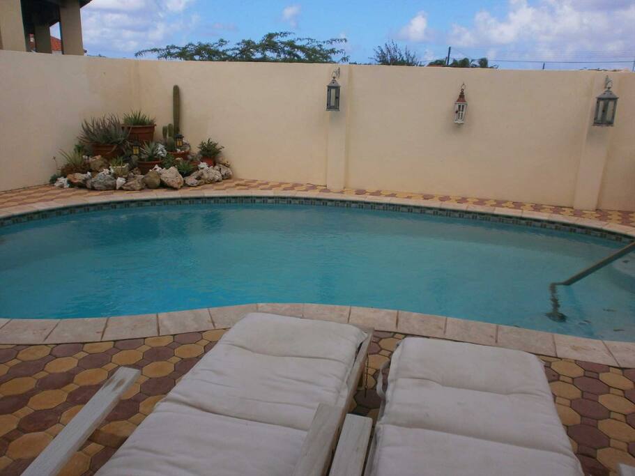 Relax on the lounge chairs beside the pool.