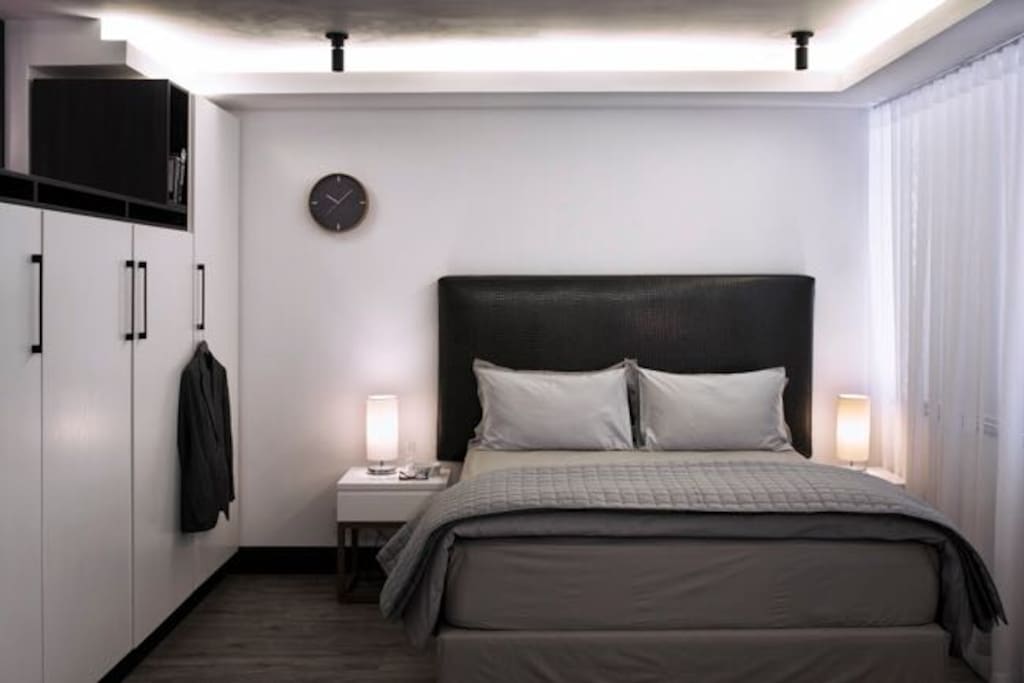 Bedroom opens onto living room; queen-sized bed.