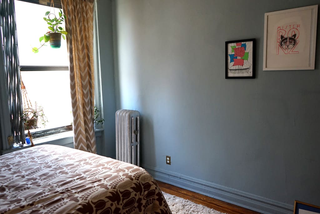 A calm bedroom with natural light makes resting easy after a long day of sightseeing.