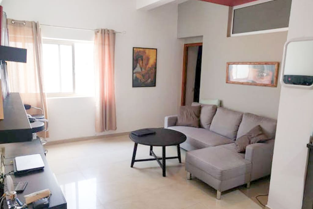 Living room with sofa, TV, WiFi.