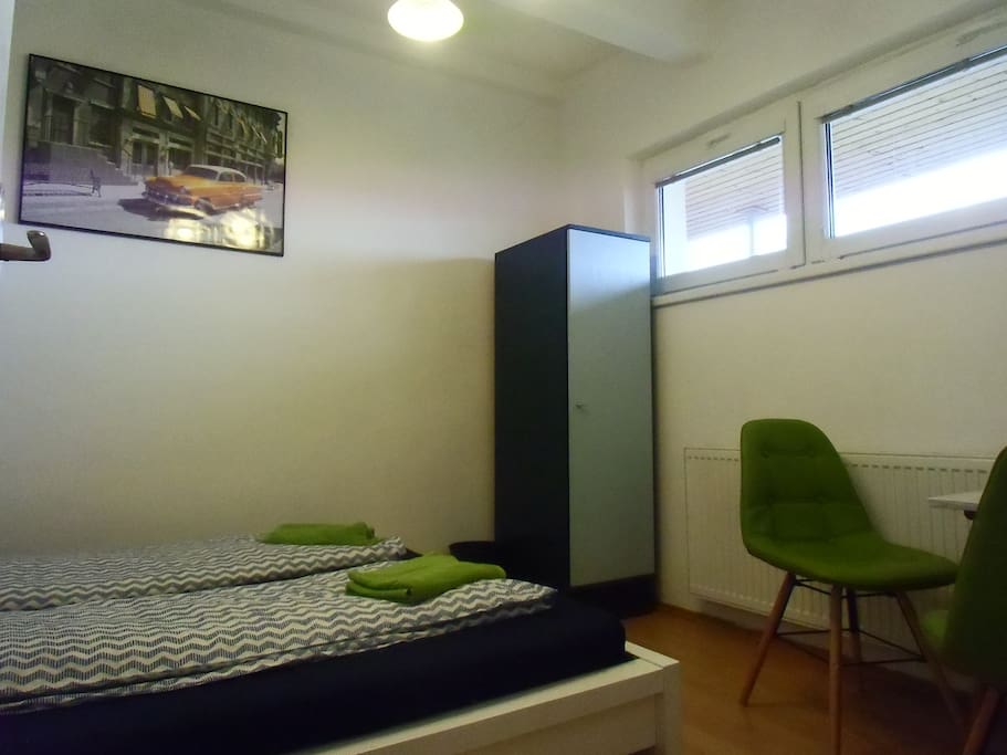 This will be your room - comfy queen size bed, a table and a pair of nice chairs.