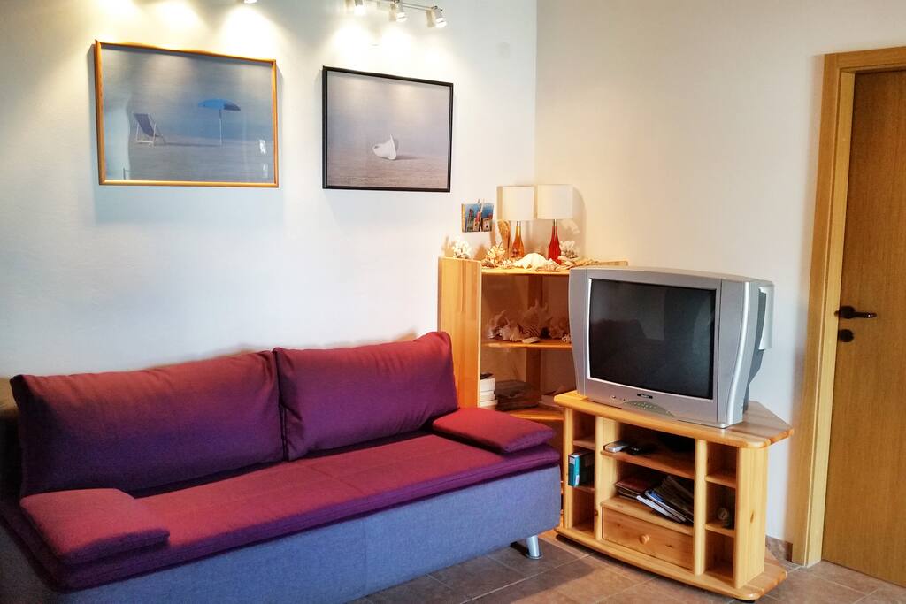 Living room with sofa for two and tv