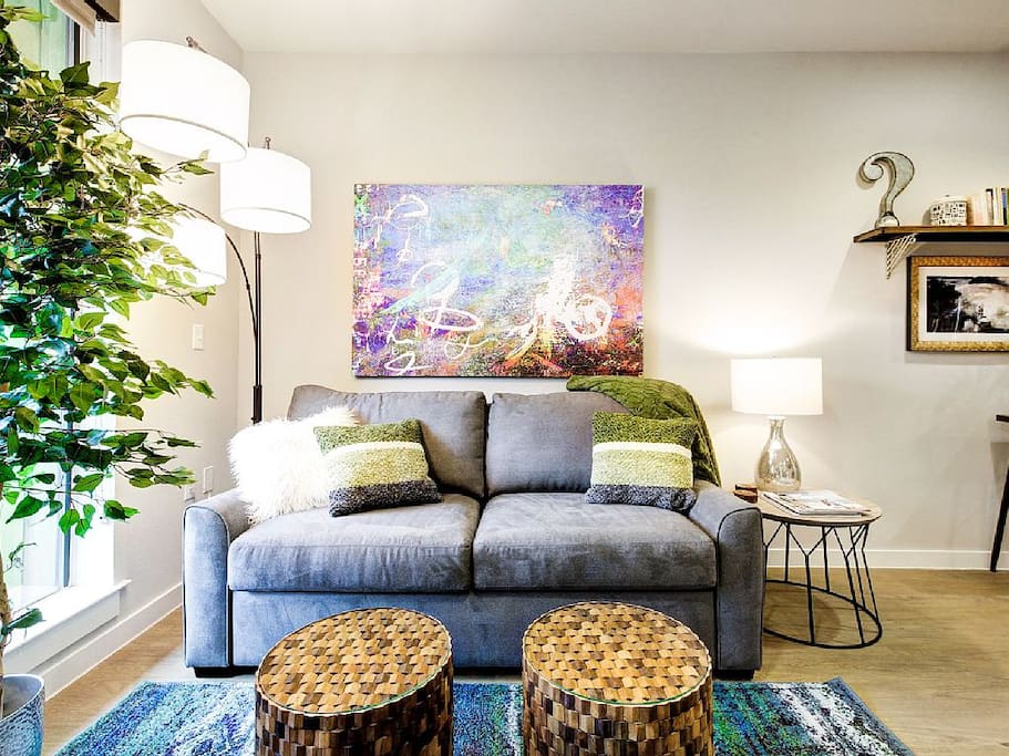 The living room gets lots of natural light, and has comfy sleeper sofa.